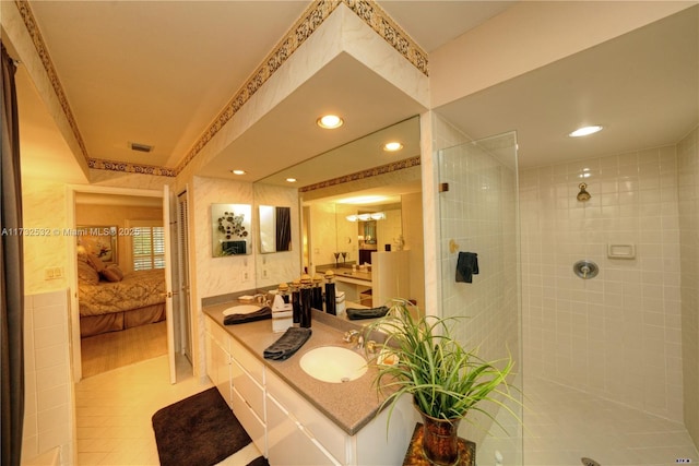 bathroom with vanity, tile patterned floors, and a tile shower