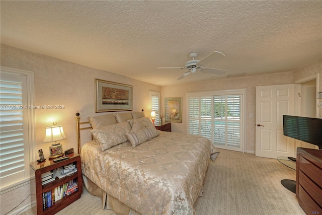 bedroom with ceiling fan, light colored carpet, access to exterior, and a textured ceiling