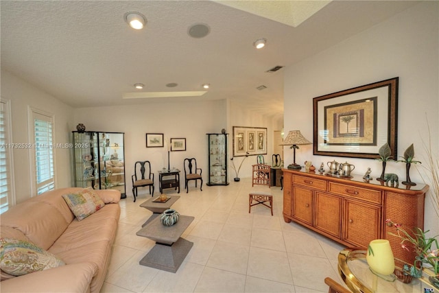 tiled living room with a textured ceiling