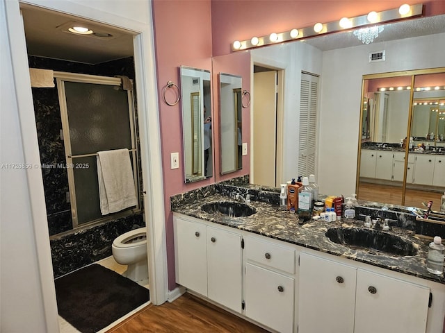 bathroom featuring vanity, wood-type flooring, and toilet