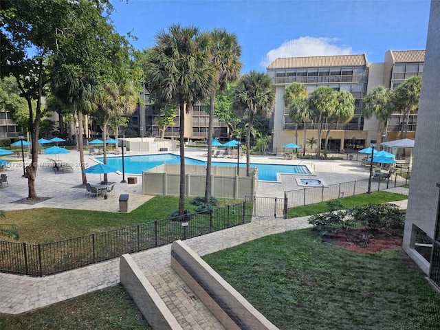 view of swimming pool with a yard and a patio