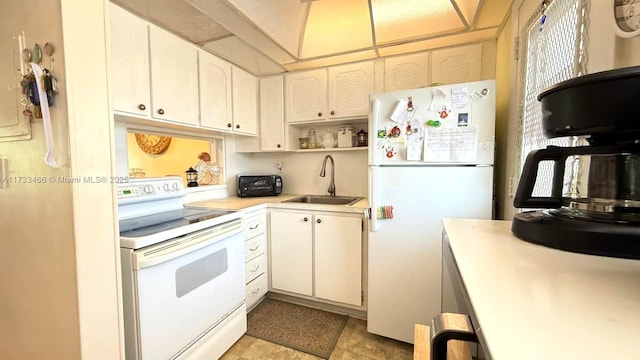 kitchen with white appliances, sink, and white cabinets