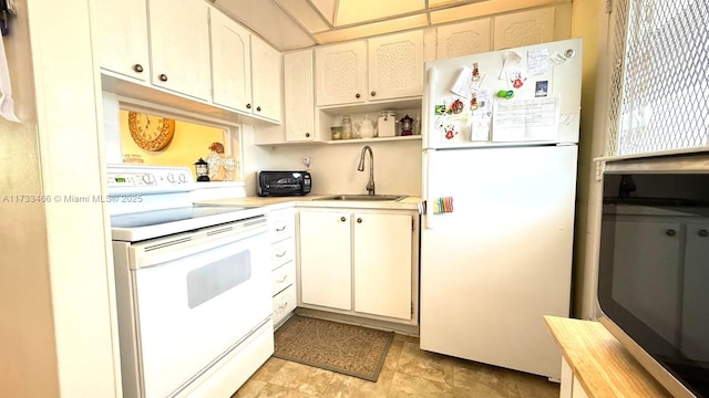 kitchen featuring white cabinetry, sink, and white appliances