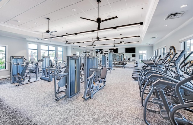 exercise room with baseboards, visible vents, and carpet floors