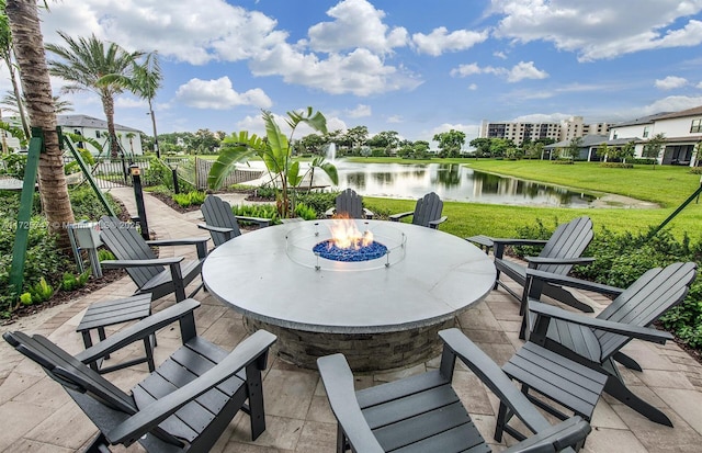 view of patio / terrace with a water view and an outdoor fire pit