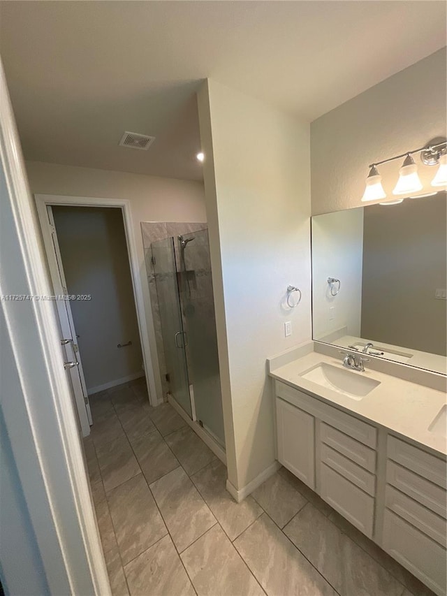 full bath featuring a shower stall, double vanity, visible vents, and a sink