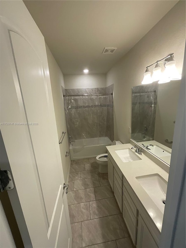 full bath featuring visible vents, toilet, a sink, shower / tub combination, and double vanity