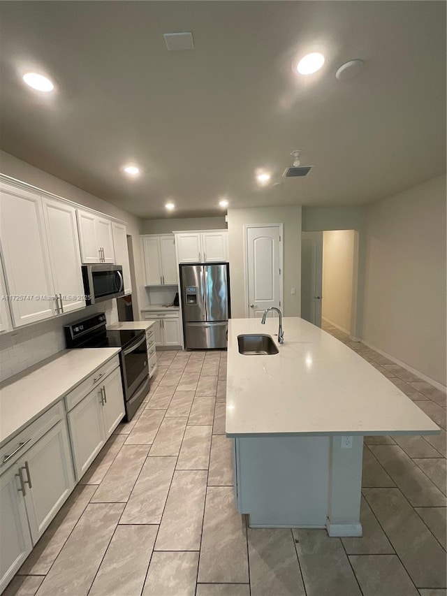 kitchen with a sink, light countertops, recessed lighting, and stainless steel appliances