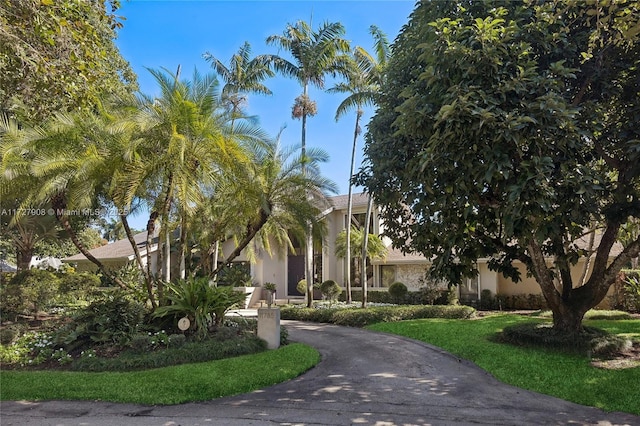 view of property's community with a lawn