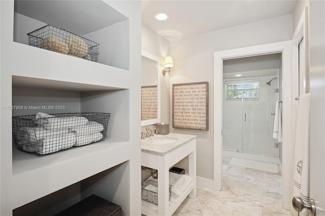 bathroom with an enclosed shower and sink