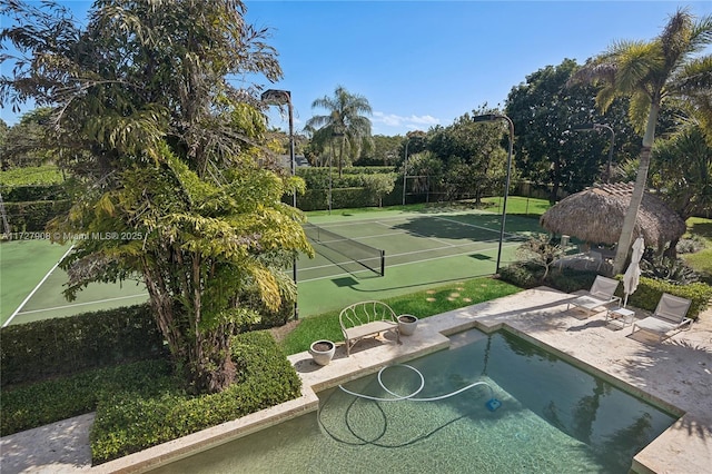 exterior space with tennis court and a gazebo