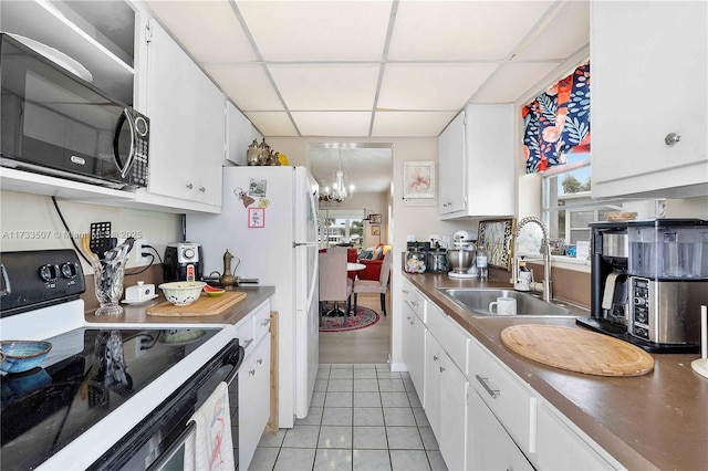 2751 E Golf Blvd Unit 2029, Pompano Beach, FL 33064 - kitchen featuring electric range oven, a sink, a drop ceiling, light tile patterned floors, and white cabinetry