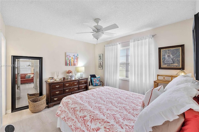 2751 E Golf Blvd Unit 2029, Pompano Beach, FL 33064 - bedroom featuring a textured ceiling, ceiling fan, and light wood finished floors