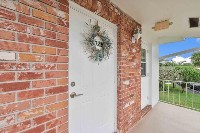 2751 E Golf Blvd Unit 2029, Pompano Beach, FL 33064 - view of exterior entry featuring brick siding