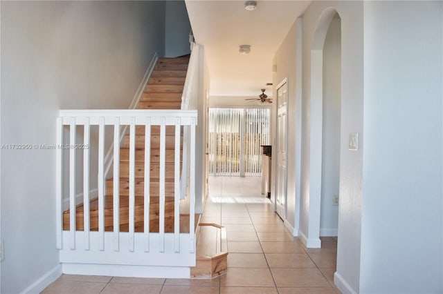 153 SE 28th Pl Unit 3, Homestead, FL 33033 - staircase with tile patterned flooring, a ceiling fan, and arched walkways