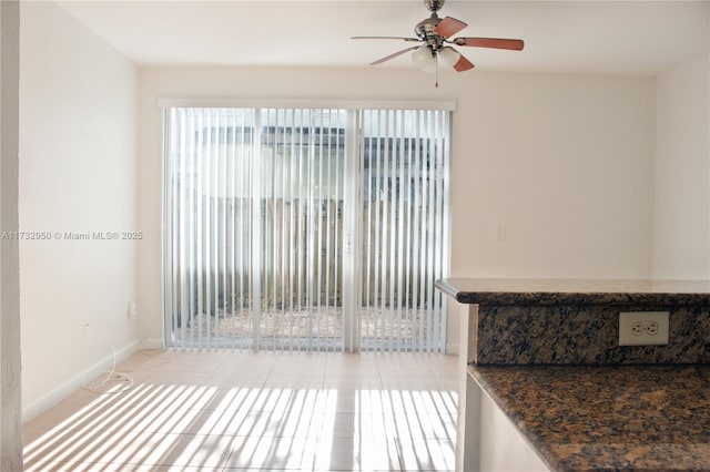 interior space featuring ceiling fan