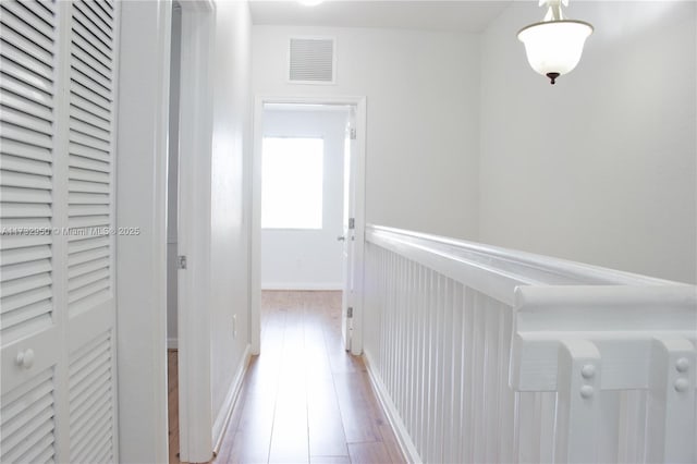 hallway with light hardwood / wood-style flooring