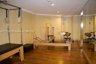 workout room featuring wood finished floors and recessed lighting