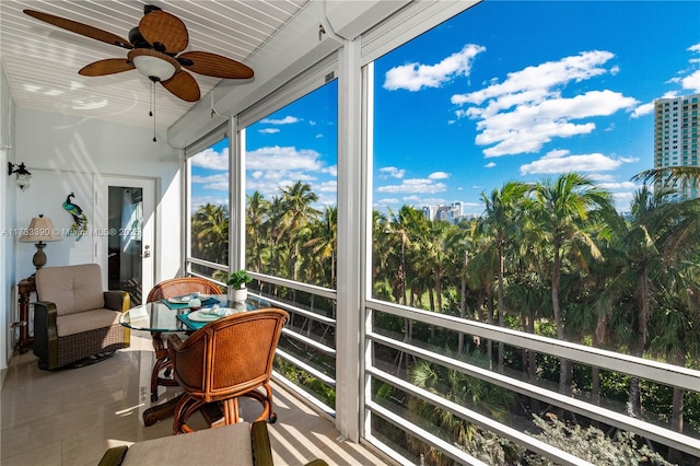 sunroom / solarium featuring ceiling fan