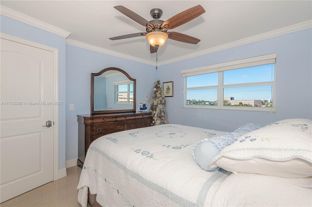 tiled bedroom with ornamental molding and ceiling fan