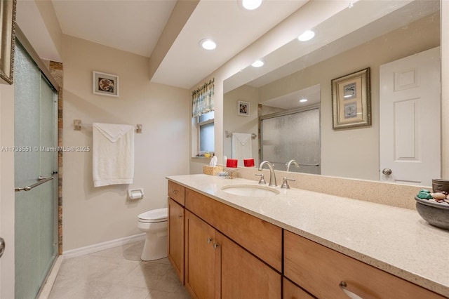 bathroom featuring vanity, tile patterned floors, toilet, and walk in shower