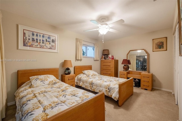 bedroom with light carpet, ceiling fan, and a closet