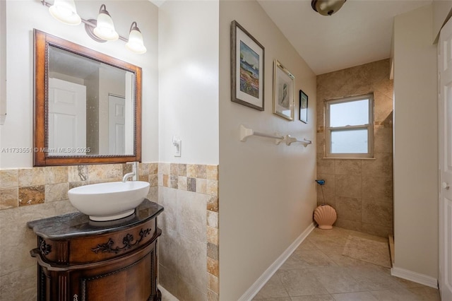 bathroom with vanity, tile patterned flooring, and tile walls