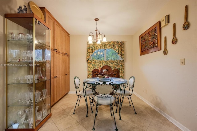 dining room with a notable chandelier and light tile patterned floors