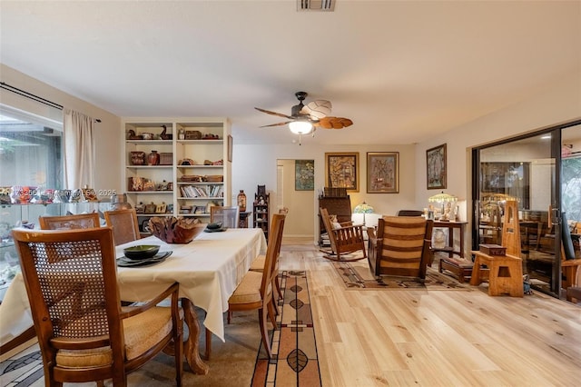 dining room with ceiling fan and light hardwood / wood-style floors