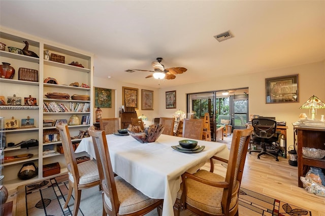 dining space with ceiling fan and light wood-type flooring