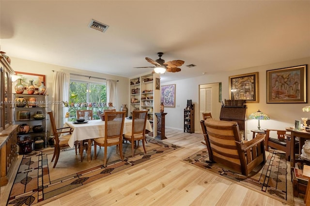 dining area with ceiling fan and light hardwood / wood-style floors