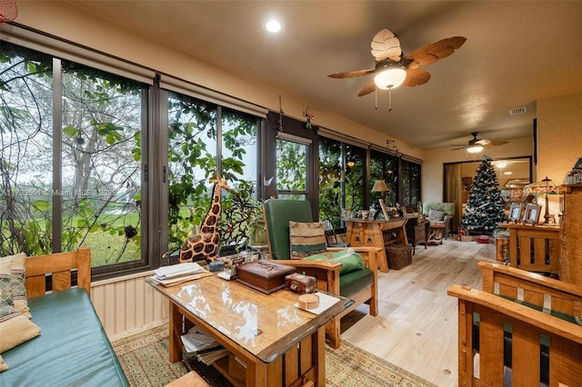 sunroom / solarium with a wealth of natural light and ceiling fan