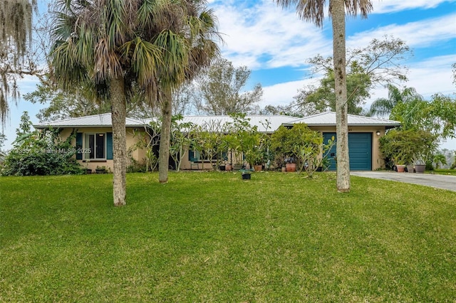 single story home featuring a garage and a front lawn