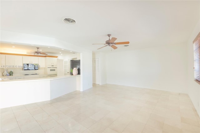 unfurnished living room featuring ceiling fan