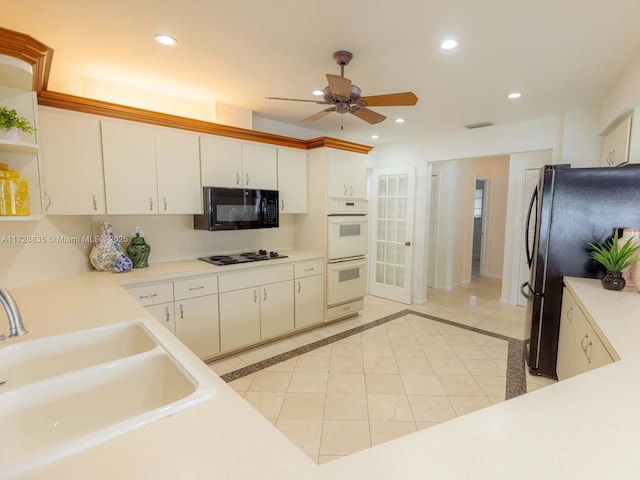 kitchen featuring stainless steel refrigerator, double oven, sink, white cabinets, and cooktop