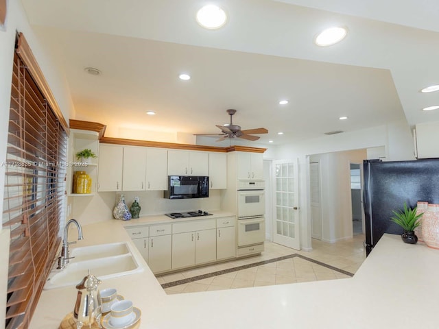 kitchen with black appliances, white cabinetry, sink, ceiling fan, and kitchen peninsula