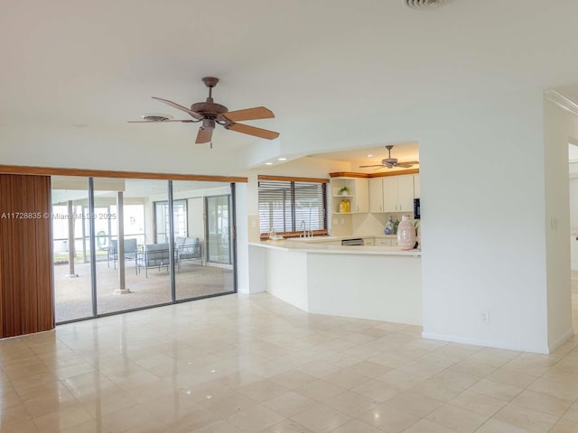 unfurnished living room with ceiling fan