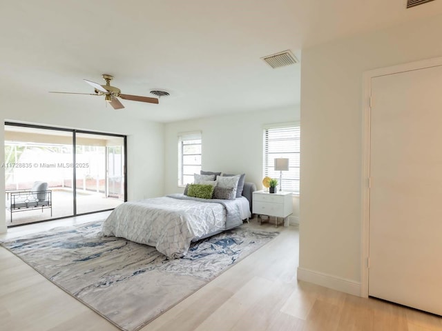 bedroom featuring ceiling fan, access to exterior, and light hardwood / wood-style flooring