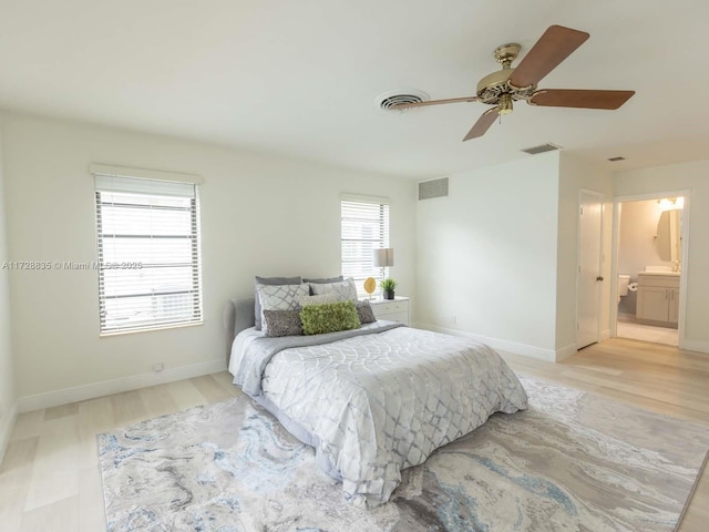 bedroom with connected bathroom, ceiling fan, and light wood-type flooring