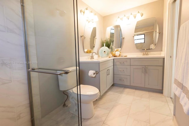 bathroom featuring vanity, tiled shower, and toilet