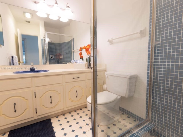 bathroom featuring walk in shower, vanity, and toilet