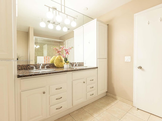 bathroom with walk in shower, tile patterned floors, and vanity