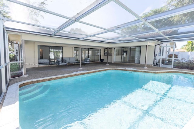 view of swimming pool featuring a lanai and a patio area