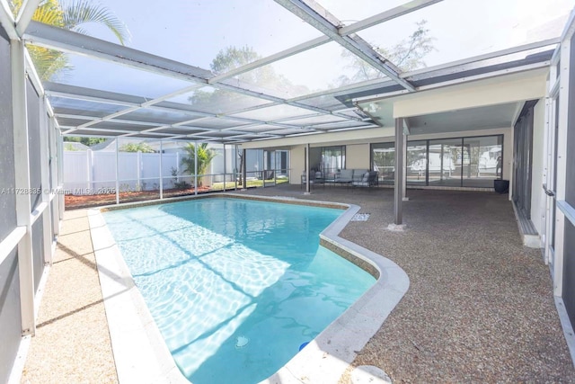 view of swimming pool featuring a lanai and a patio area