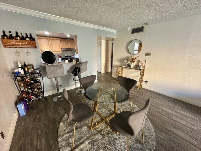 dining area featuring crown molding, dark hardwood / wood-style floors, and a textured ceiling