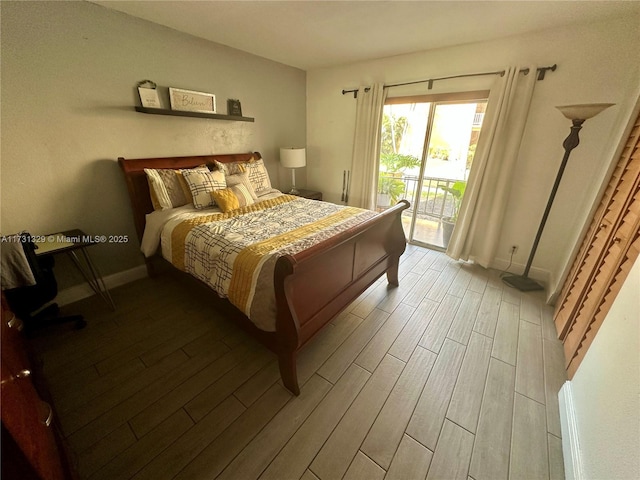 bedroom featuring access to exterior and hardwood / wood-style floors