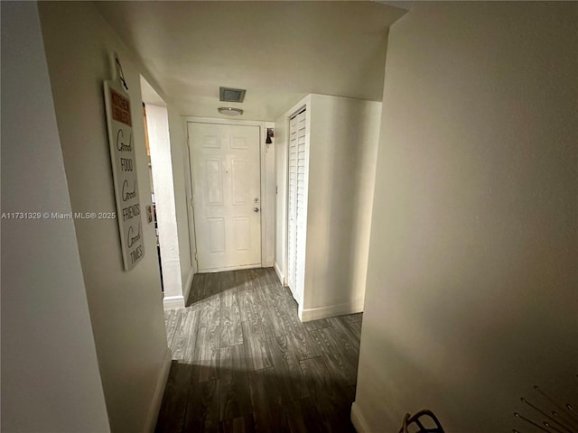 corridor featuring dark hardwood / wood-style floors