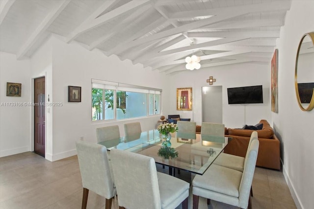 dining room featuring light tile patterned flooring and lofted ceiling with beams