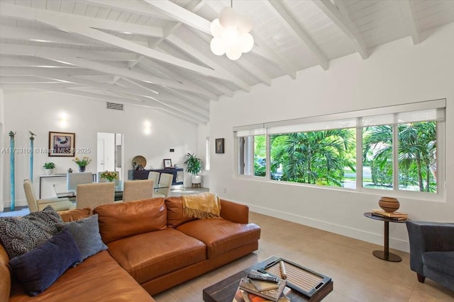 living room with beamed ceiling and high vaulted ceiling