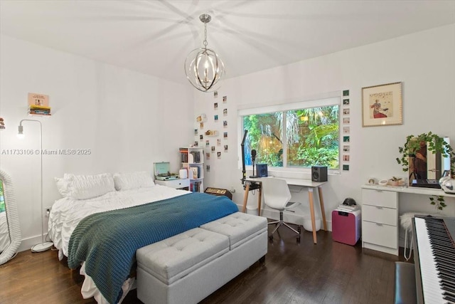 bedroom with dark hardwood / wood-style flooring and a notable chandelier